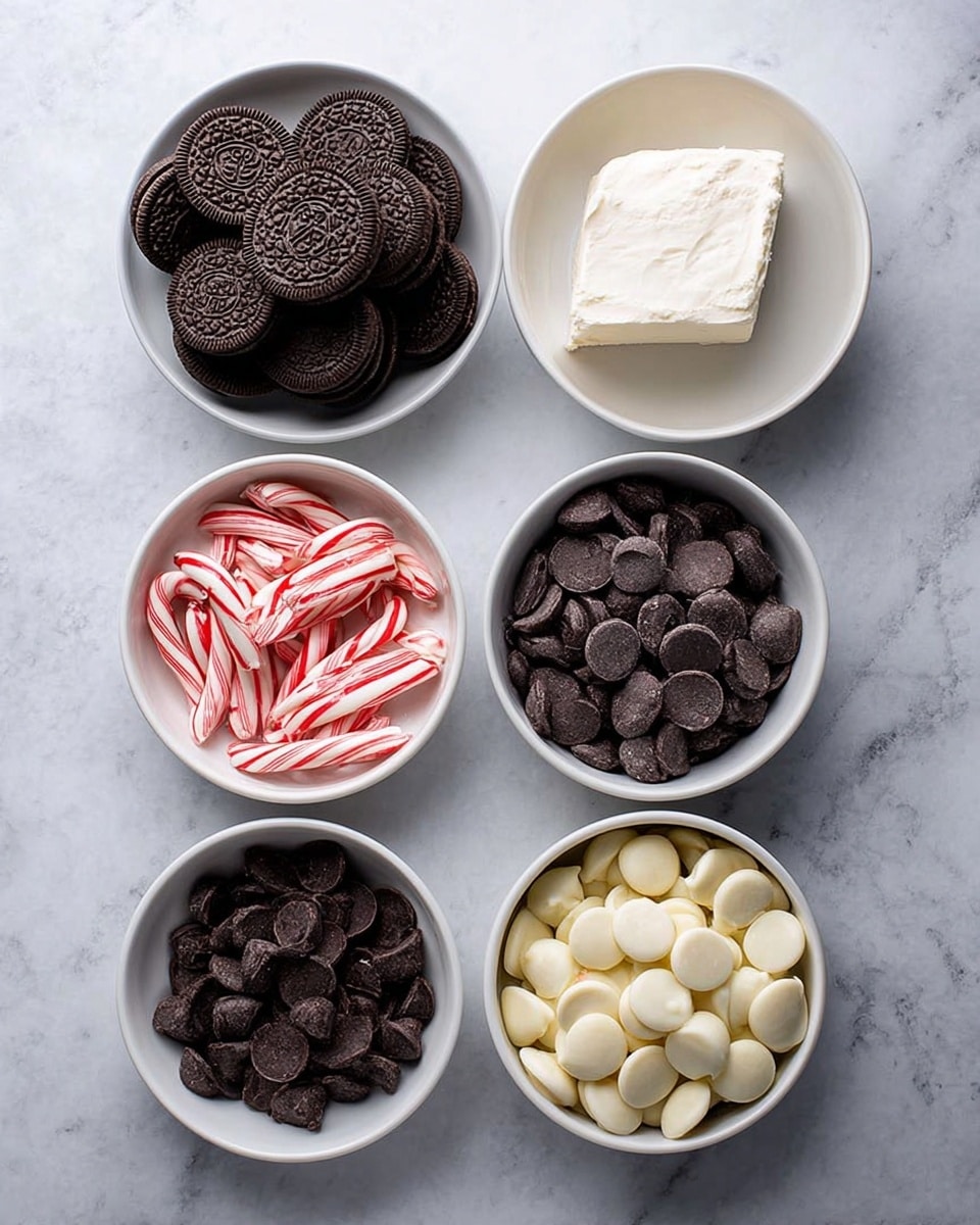 Five white bowls are placed on a white marbled surface, each containing different ingredients. The top left bowl holds many dark brown sandwich cookies stacked together. To the right, a bowl has a large piece of white cream cheese with a smooth texture. Below the cookies, a bowl contains striped red and white small candy canes scattered inside. To the right of the candy canes, there is a bowl filled with dark brown chocolate chips, round and flat. Below these, the last bowl is full of white chocolate chips, also round and flat. The arrangement is neat and evenly spaced. Photo taken with an iphone --ar 4:5 --v 7