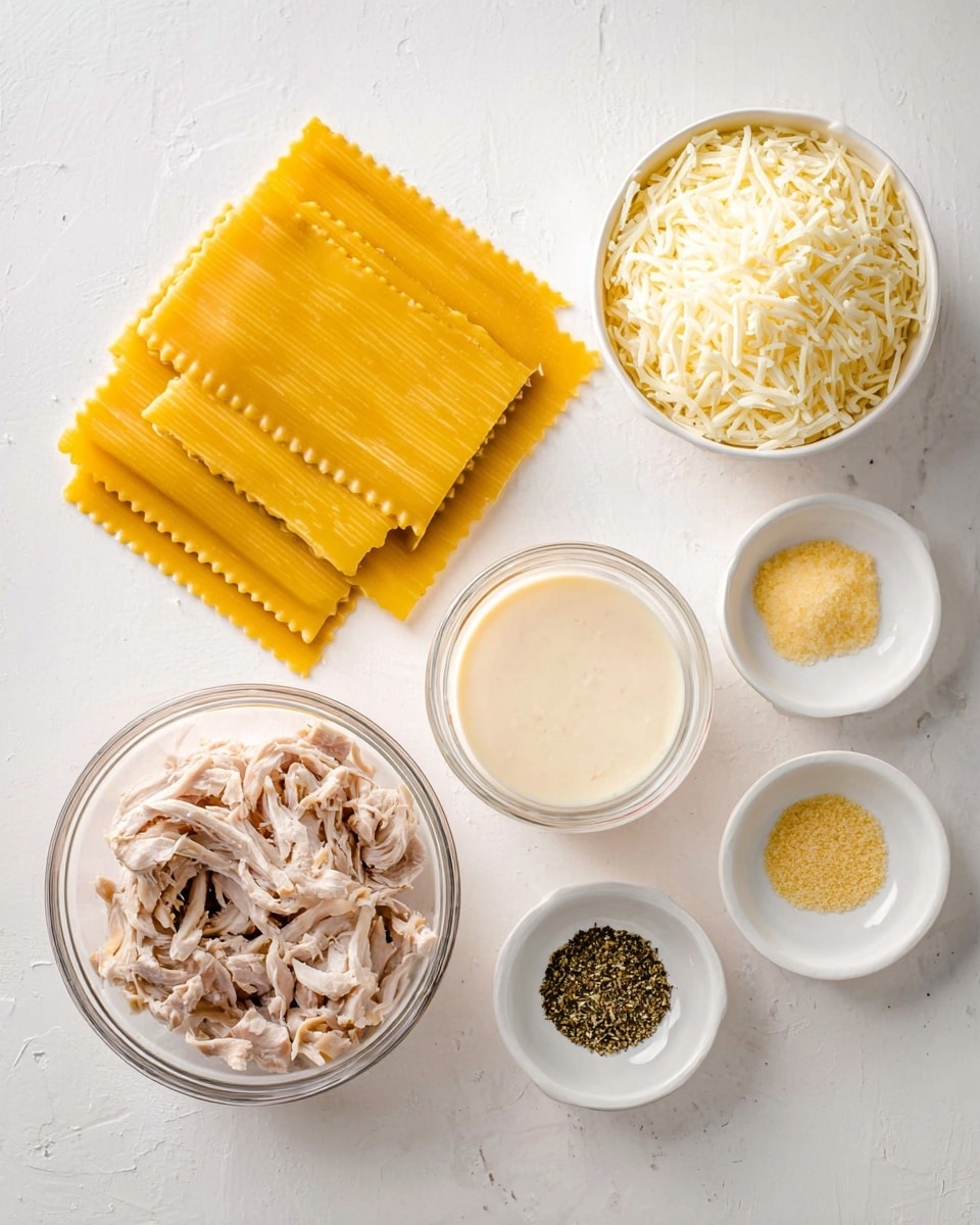 The image shows several ingredients laid out on a white marbled surface. There are six rectangular lasagna sheets with a bright yellow color and ridged edges, arranged in a slightly fanned stack on the left side. Below them is a small white bowl filled with finely grated pale yellow cheese. Next to this is a clear glass bowl with a smooth, creamy white sauce, slightly thick in texture. To the right of the sauce is a glass measuring cup filled with shredded cooked chicken in light brown and beige tones. Above this cup sits a larger white bowl heaped with shredded mozzarella cheese, its soft white strands loosely piled. On the far right, three small white bowls hold different seasonings: one with a pale beige powder, the next with bright yellow zest, and the last with dark green dried herbs. The setup is neat and clean, evenly spaced, with soft lighting. Photo taken with an iphone --ar 4:5 --v 7