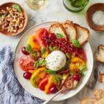 Lemon-Thyme Oil Drizzled Burrata Platter with Heirloom Tomatoes, Peach, and Herbs Recipe
