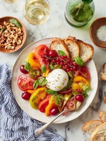Lemon-Thyme Oil Drizzled Burrata Platter with Heirloom Tomatoes, Peach, and Herbs Recipe