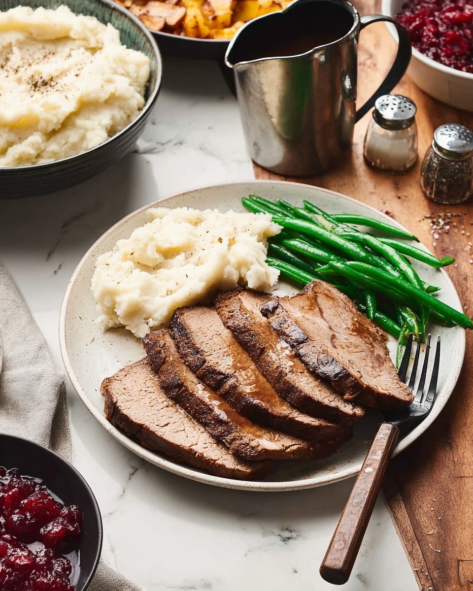 A white plate sits on a white marbled surface with three thick slices of brown roasted meat layered in the center, showing a slightly crispy texture on the edges. To the left of the meat, there is a creamy white mound of mashed potatoes, soft and uneven in texture. On the right side of the plate are bright green cooked green beans, placed next to the meat with a black fork resting among them. Around the plate, a wooden table holds other dishes, including a bowl of mashed potatoes, a black bowl with red cranberry sauce, a metal pitcher of dark sauce, and small salt and pepper shakers. Photo taken with an iphone --ar 4:5 --v 7