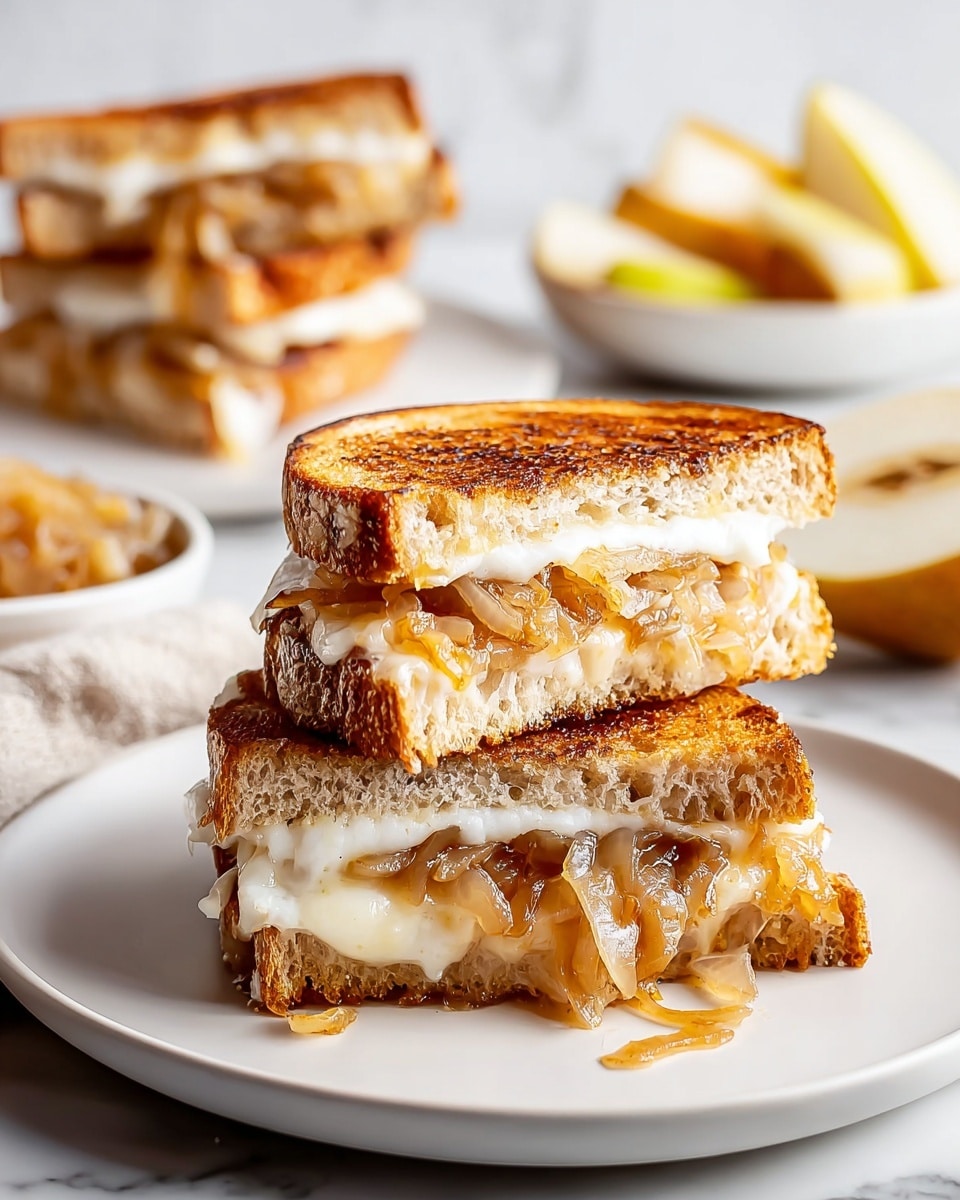A sandwich is stacked in two halves on a white plate, each half showing two slices of toasted golden brown bread with a slightly crunchy texture. Between the bread slices are melted white cheese layers with a smooth, creamy look, and caramelized onions in a light golden brown color that appear soft and glossy, spilling slightly out from the sides. In the background, there is another sandwich half on a white plate and diced light yellow pears, all set on a white marbled surface. photo taken with an iphone --ar 4:5 --v 7