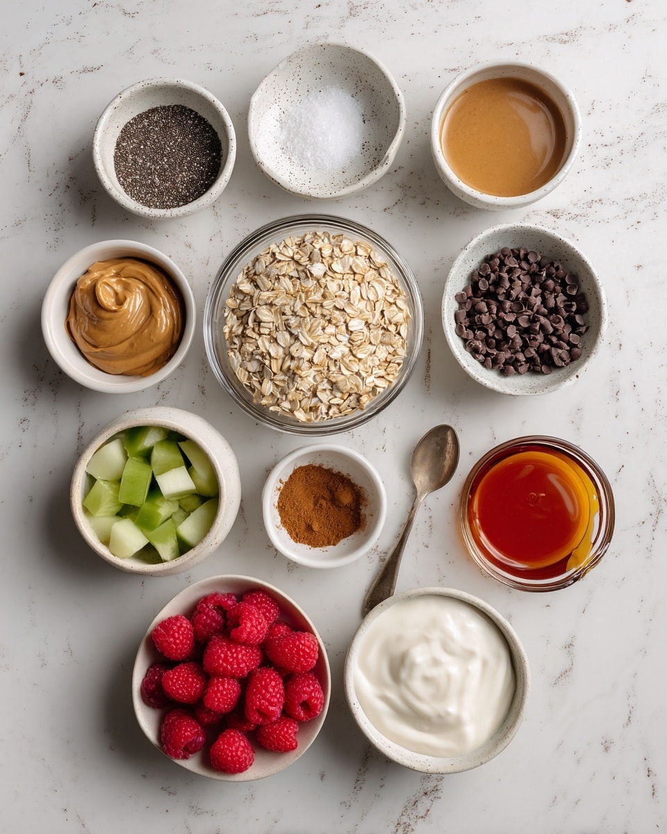 The image shows eleven small bowls arranged on a white marbled surface, each holding different ingredients. In the center is a clear glass bowl filled with light brown oats. Surrounding it clockwise from the top left are a white bowl with smooth peanut butter, a speckled white dish with fine white salt, a small white bowl filled with black chia seeds, another white bowl with light brown vanilla liquid, a white bowl full of dark chocolate chips, a white bowl with green chopped fresh fruit, a white bowl with bright red raspberries, a white bowl holding creamy white yogurt with a spoon, a white bowl of light brown applesauce, a small white dish with ground cinnamon, and a small glass cup holding amber maple syrup. The bowls vary in size and texture but all are white or clear. Photo taken with an iphone --ar 4:5 --v 7