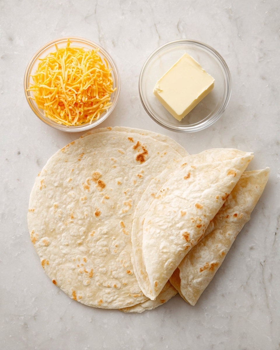 This image shows three large folded white tortillas placed on a white marbled surface to the right. To the left, there are two small clear glass bowls: one filled with shredded orange-yellow cheddar cheese and the other holding a small cube of pale yellow butter. The textures include the soft, slightly browned and cracked surface of the tortillas, the fine and slightly rough texture of the shredded cheese, and the smooth, solid texture of the butter cube. Photo taken with an iphone --ar 4:5 --v 7
