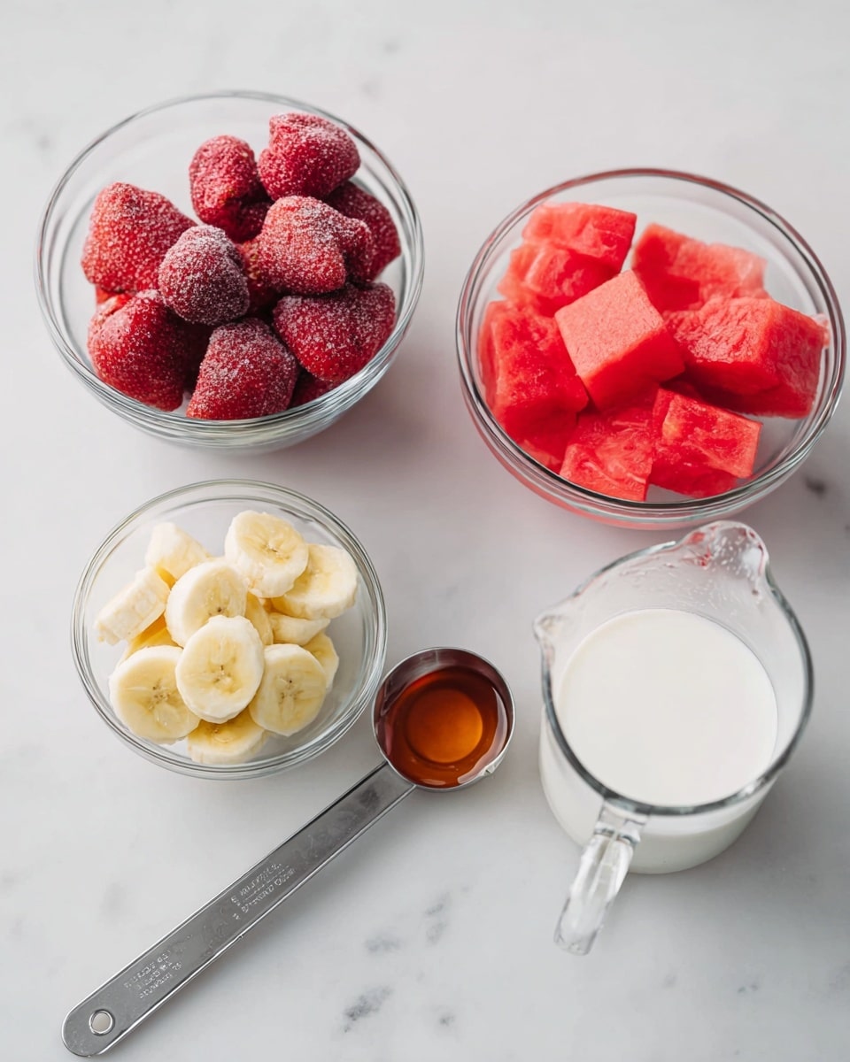 The image shows five small glass bowls and a metal measuring spoon on a white marbled surface. One bowl is filled with frozen strawberries, showing a frosty texture and deep red color. Another bowl contains bright red watermelon pieces cut into chunks. A small bowl in the front has light yellow banana slices. There is a clear glass measuring cup with white milk, and beside it is a metal measuring spoon filled with amber honey. The items are neatly arranged with ample space between them, creating a clean and fresh look. photo taken with an iphone --ar 4:5 --v 7