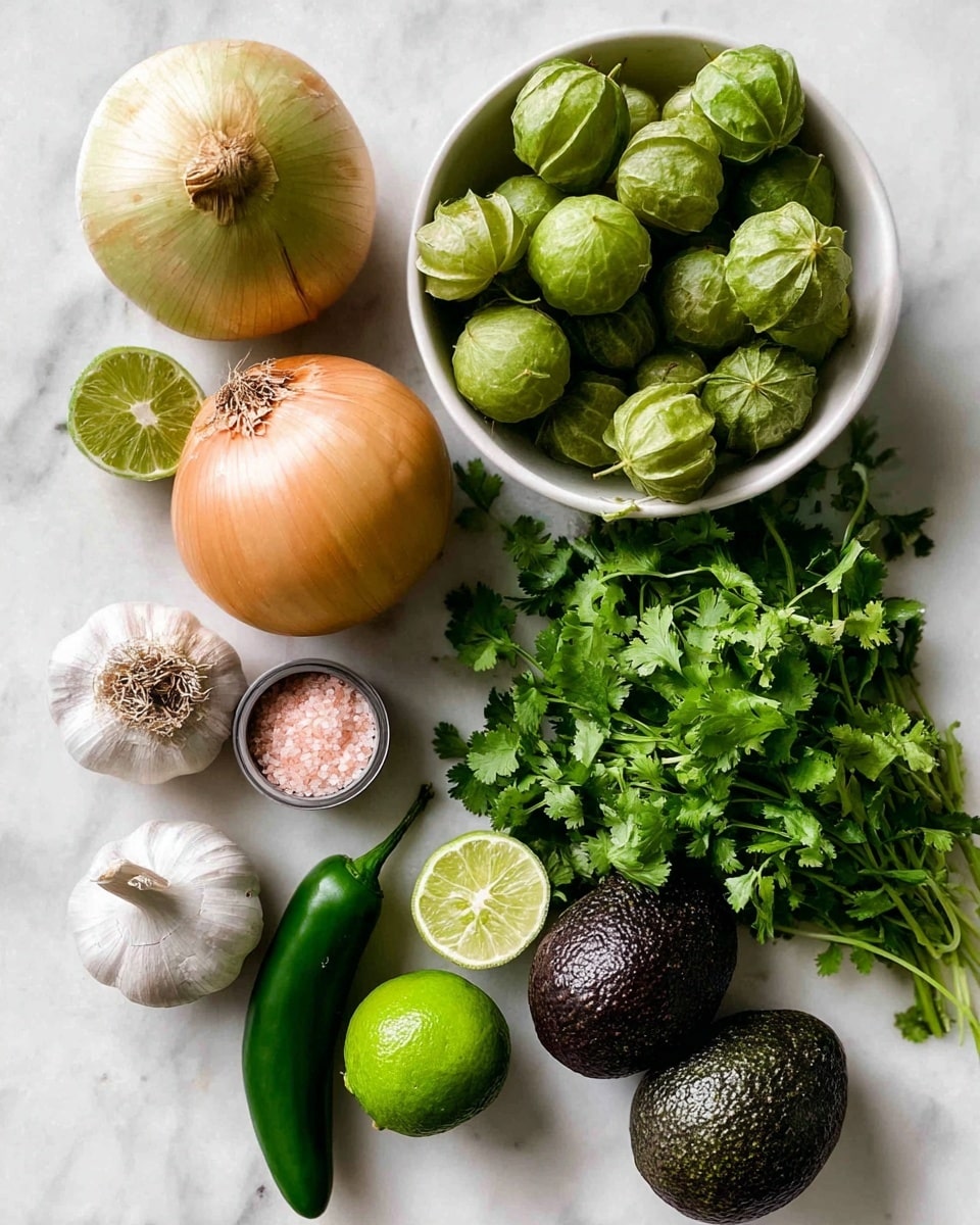 The image shows fresh ingredients arranged on a white marbled surface. A white bowl filled with green tomatillos sits at the top right, with a few tomatillos outside the bowl nearby. To the left, there is a whole onion with light yellow and brown skin. Below the onion, a bright green lime sits next to a bulb of garlic with some cloves showing. A long green serrano pepper is placed near a small container of pink sea salt. Two dark green avocados are placed side by side near a bunch of fresh cilantro with leafy green stems spreading out. The colors are natural and vibrant, and the textures range from the smooth lime and avocados to the rough tomatillo skins and leafy cilantro. Photo taken with an iphone --ar 4:5 --v 7