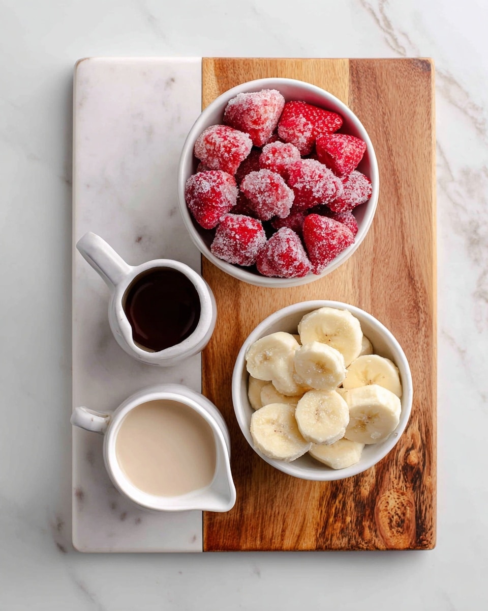 A white bowl filled with bright red frozen strawberries covered in frosty ice crystals is placed on the top left of a white marbled cutting board with a wooden section on the right. Below it, there is a white bowl filled with light yellow frozen banana slices showing a frosted texture. To the top right on the wooden part of the board, there is a small white pitcher with a dark vanilla liquid, and to the bottom left on the marbled white part, there is a small white pitcher holding non-dairy milk of a light beige color. The whole setting is on a white marbled surface. Photo taken with an iphone --ar 4:5 --v 7