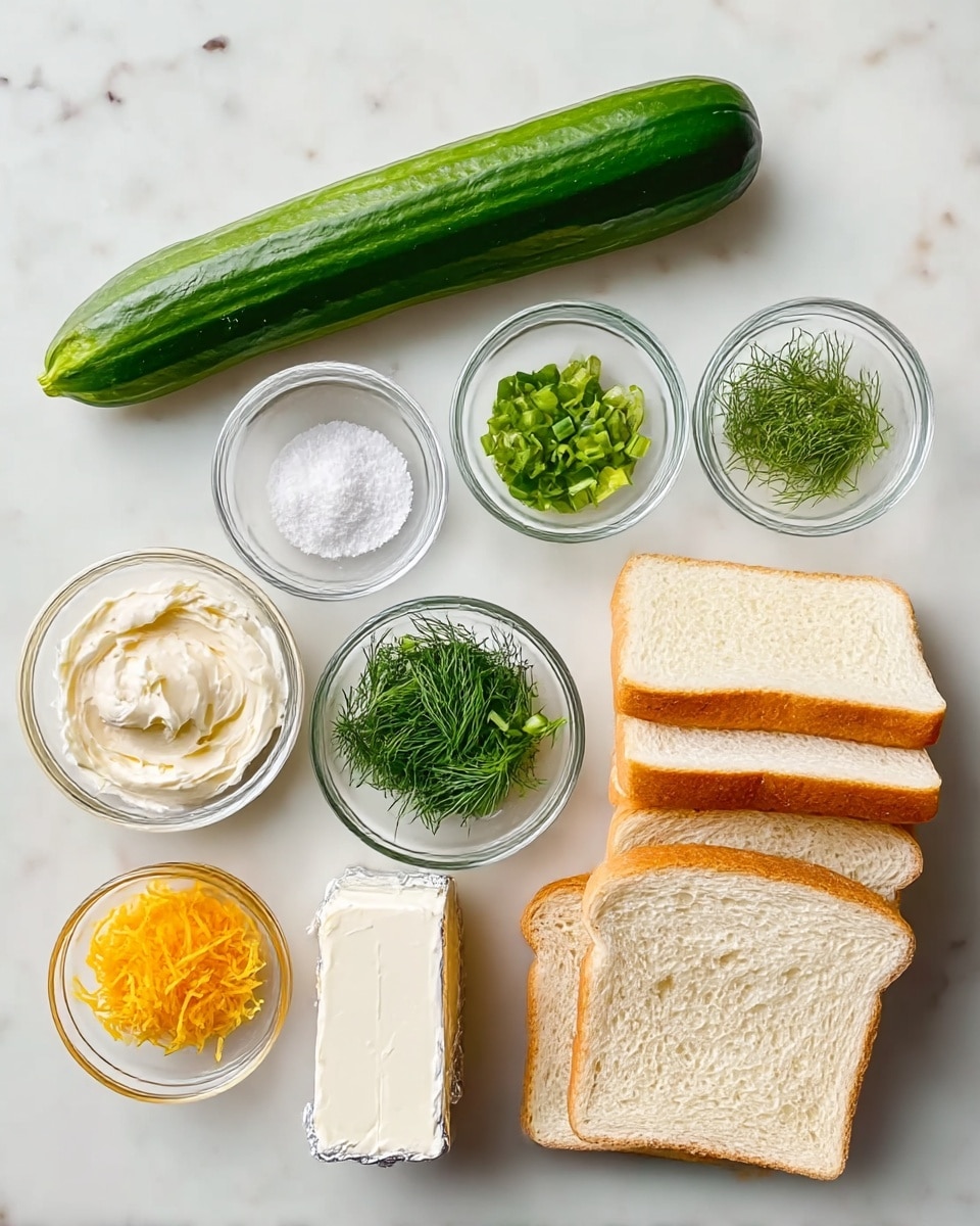 The image shows all the ingredients neatly arranged on a white marbled surface. There is a long cucumber at the top, three small clear glass bowls filled with salt, fresh dill, and chopped green onions below it. To the left, a small clear glass bowl contains a creamy white spread, and below it another small bowl holds an orange lemon zest. In the center, an unwrapped soft white cream cheese block sits partially covered in silver foil. On the right side, there are four thick slices of white bread stacked in two piles. photo taken with an iphone --ar 4:5 --v 7