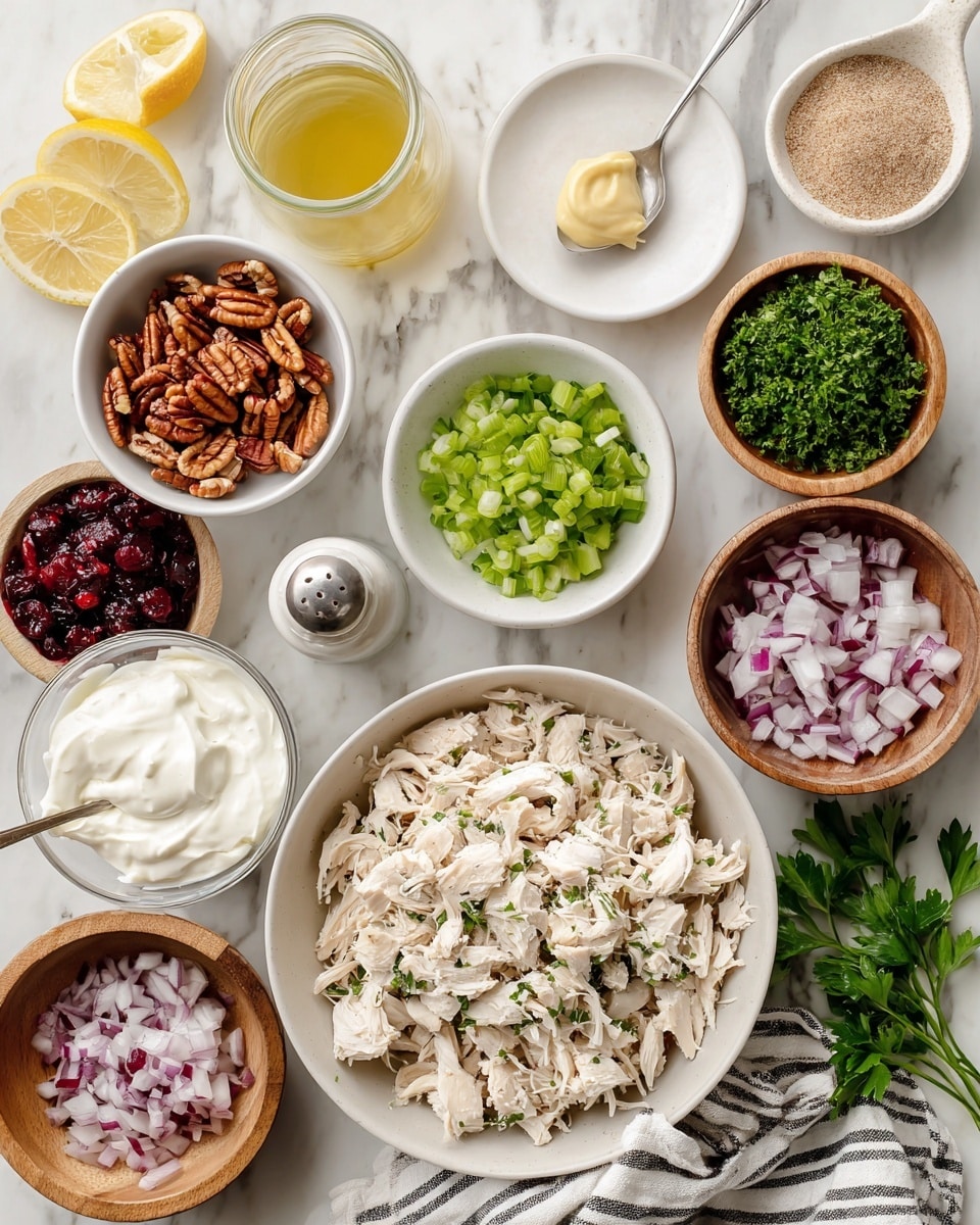 A white bowl filled with chopped rotisserie chicken sits on the bottom right over a striped cloth on a white marbled surface. Surrounding it are small white bowls with different ingredients: chopped celery in the middle top, chopped parsley to the left, pecans on the far left, dried cranberries at the bottom left, and mayonnaise to the upper right. A small white plate at the top center holds a dollop of dijon mustard, while a small white bowl below it contains light brown garlic powder. Next to the mustard is a glass filled with lemon juice and a salt shaker. A wooden bowl with plain Greek yogurt and a spoon rests at the bottom left. A small wooden bowl with chopped red onion is placed in the center. Some green parsley sprigs are also visible on the white marbled surface. The scene is brightly lit, showing all ingredients clearly, photo taken with an iphone --ar 4:5 --v 7