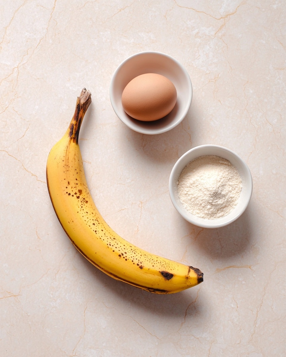 A single yellow banana with a few brown spots lays curved on a white marbled surface. Above it are two small white bowls side by side; the bowl on the left holds a smooth brown egg, while the bowl on the right is filled with a fine white powder. The setup is simple and clean with soft lighting. photo taken with an iphone --ar 4:5 --v 7