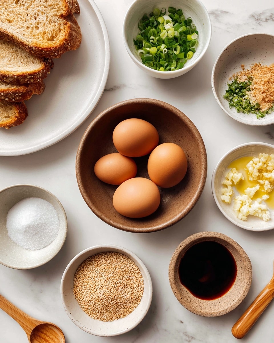 The image shows several small bowls with different ingredients arranged on a white marbled surface. In the center, there is a brown bowl holding four brown eggs. To the top left, part of a white plate holds two slices of bread. Surrounding the eggs, from the top left going clockwise, there is a small white bowl with white sugar crystals, a bowl with chopped green onions, a white bowl with light yellow grated ginger, another white bowl with finely chopped garlic, a bowl filled with light brown roasted sesame seeds, and a small container of dark soy sauce with a wooden handle. There is also a small bowl containing clear, light brown liquid labeled