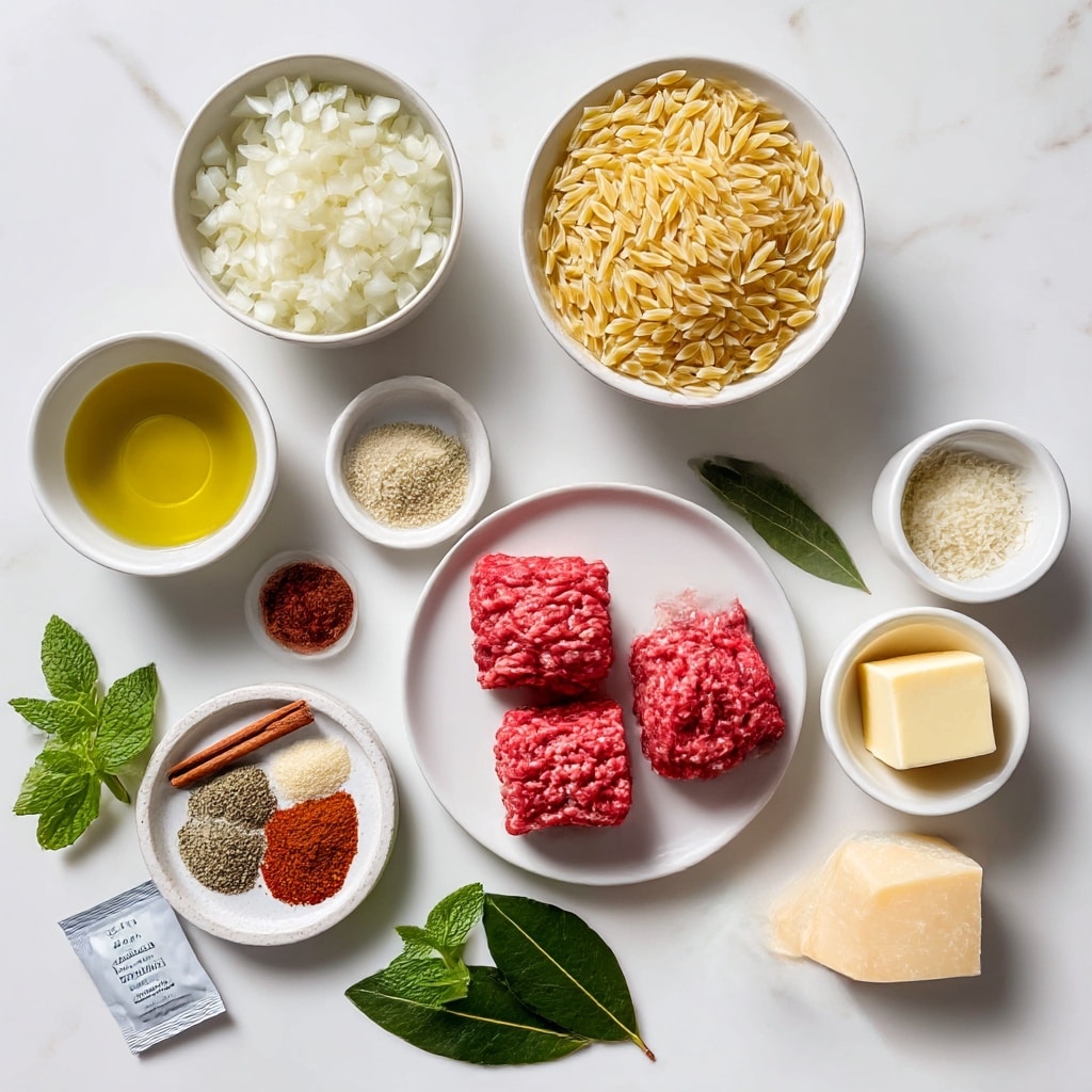 The image shows various cooking ingredients arranged on a white marbled surface. In the center, there is a white plate with several pieces of raw ground beef that are bright red with a slightly textured surface. Above that, a white bowl contains uncooked orzo pasta, small rice-shaped pieces in a pale yellow color. To the left, a white bowl holds chopped white onions with a slightly translucent texture. A small white bowl with olive oil has a golden liquid. Near the center, a round white dish contains a mix of spices and seasonings including a cinnamon stick, red spice powder, and salt. A chunk of pale yellow Parmesan cheese rests nearby with a firm texture and sharp edges. Fresh green mint and parsley leaves are placed on the surface below the cheese. A single dark green bay leaf lies to the right of the herbs. Towards the top right, a small white bowl has a square piece of pale yellow butter, and next to it, a white bowl holds finely minced garlic in a pale yellowish color. A tiny white bowl contains dark red tomato paste. A small white packet labeled chicken stock is also present. The overall scene is bright and clean with soft natural light, photo taken with an iphone --ar 4:5 --v 7