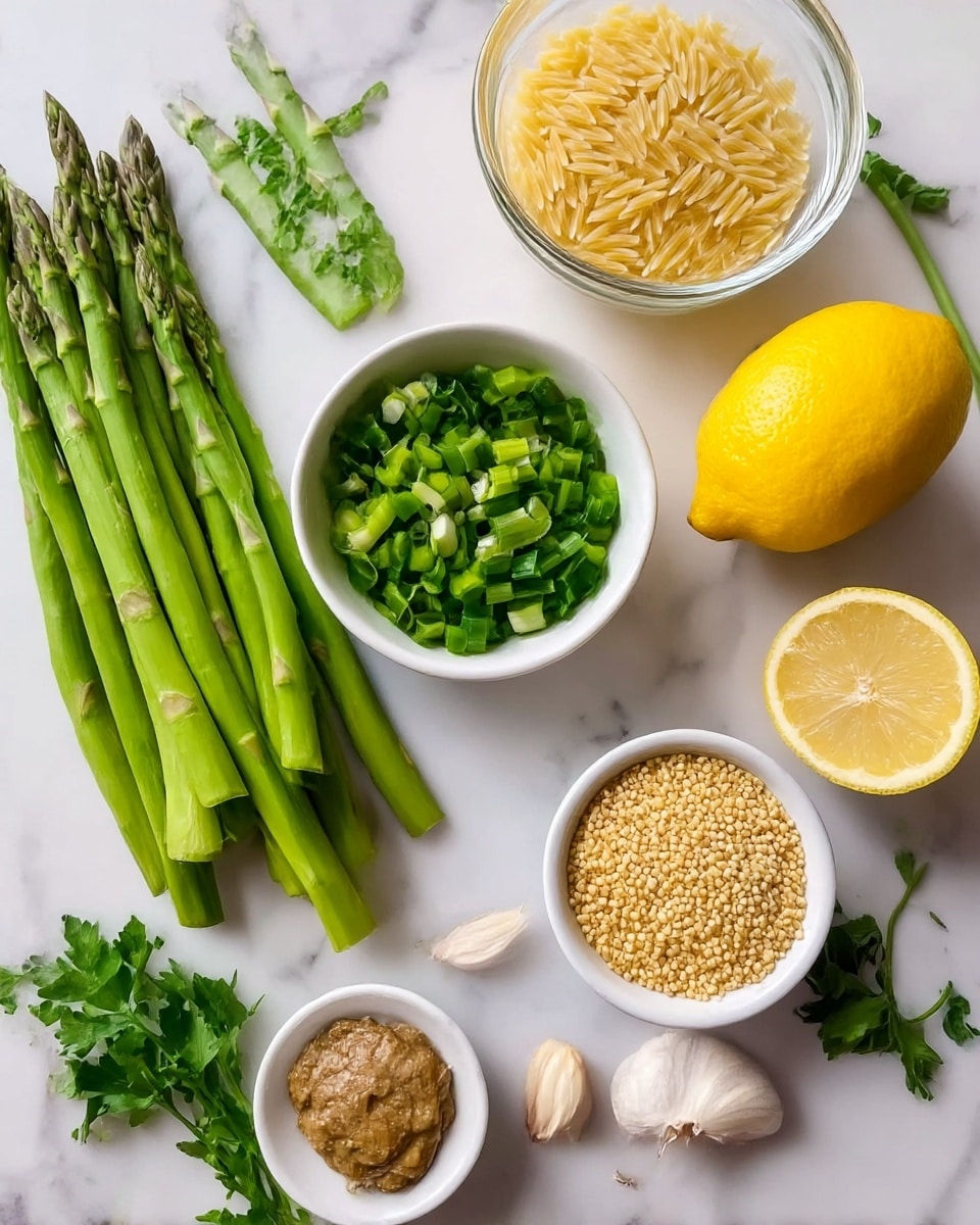 The image shows a white marbled surface with an arrangement of fresh ingredients. There are several bright green asparagus stalks lying on the left side. Next to them, there is a small white bowl filled with chopped green onions, and above it, a clear glass bowl with dry orzo pasta. On the right side lies a whole yellow lemon with a half lemon showing the inside. In front, there is a small white bowl with a brown paste, a small white bowl filled with a golden grain (possibly couscous or quinoa), two cloves of garlic, and some fresh green herbs around the edges. Photo taken with an iphone --ar 4:5 --v 7