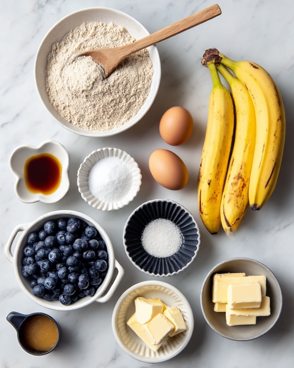 The image shows a white bowl with light brown whole wheat flour in the top center with a wooden spoon inside. To the right, there is a bunch of three bright yellow bananas with some brown spots on the skin. Below the bananas, there is a white ridged bowl holding two brown eggs. Next to the eggs is a small dark fluted bowl of white salt. In the middle below the flour is a white bowl with two handles filled with fresh dark blue blueberries. Below the blueberries is a small white bowl of baking soda. On the left side of the image, starting at the top, there is a white flower-shaped bowl with a light brown liquid vanilla extract, next to it is a black measuring cup filled with light brown butter. Below that is a small white bowl with two pieces of pale yellow butter, and next to it is a small dark gray bowl with unsweetened apple sauce. Everything is placed on a white marbled surface. photo taken with an iphone --ar 4:5 --v 7