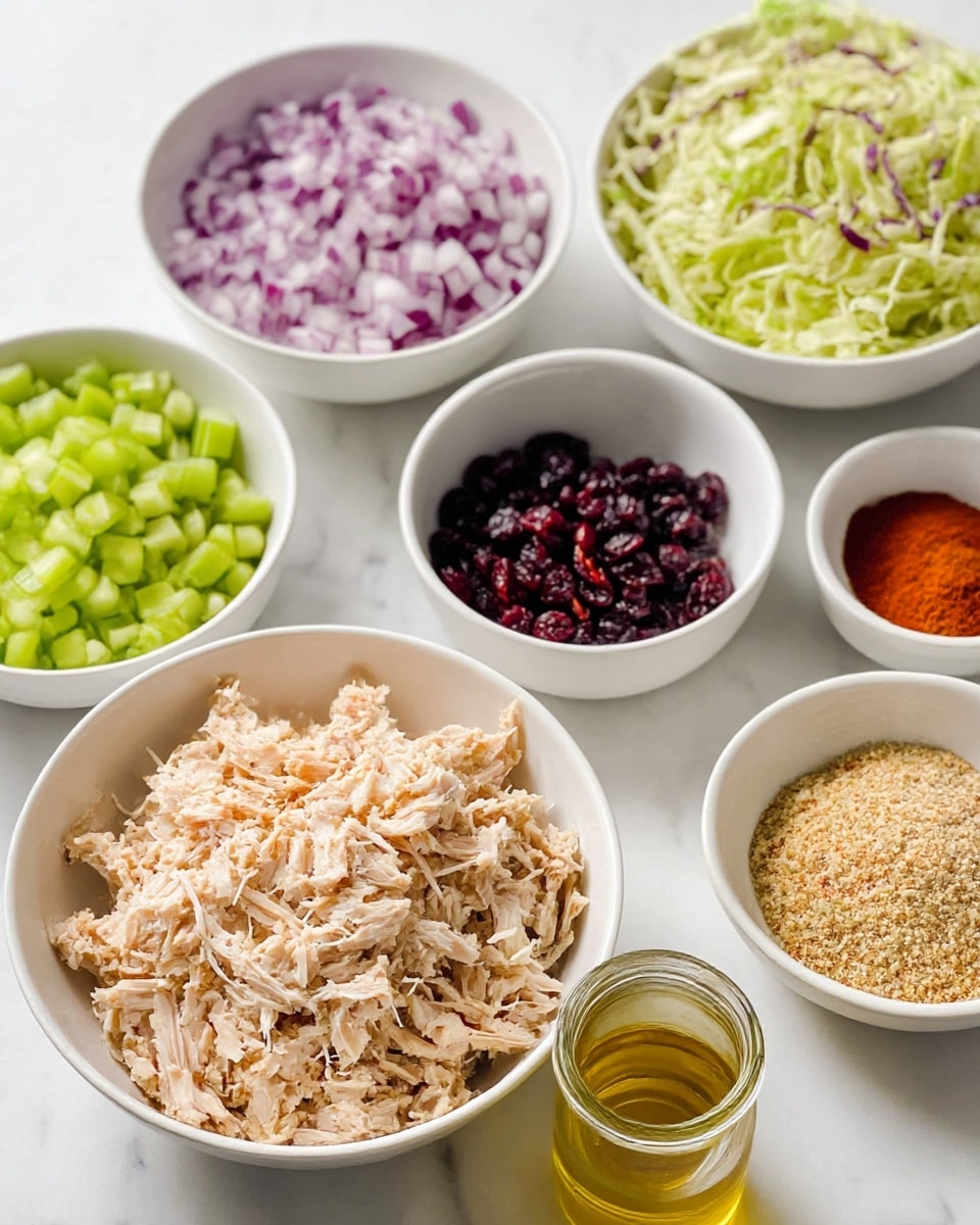 The image shows several bowls of ingredients arranged on a white marbled surface. In the front center is a white bowl filled with shredded light beige meat. To the left, a white bowl holds small, bright green chopped celery pieces. Behind it, a white bowl has finely chopped red onions with white and purple tones. On the right side, a white bowl contains shredded green and purple cabbage mixed together. There are smaller white bowls with dark red dried cranberries, a mixture of light yellow and red spices, and a grainy beige sauce. A glass jar in the front holds clear golden olive oil, and a small glass with a light amber liquid sits nearby. photo taken with an iphone --ar 4:5 --v 7